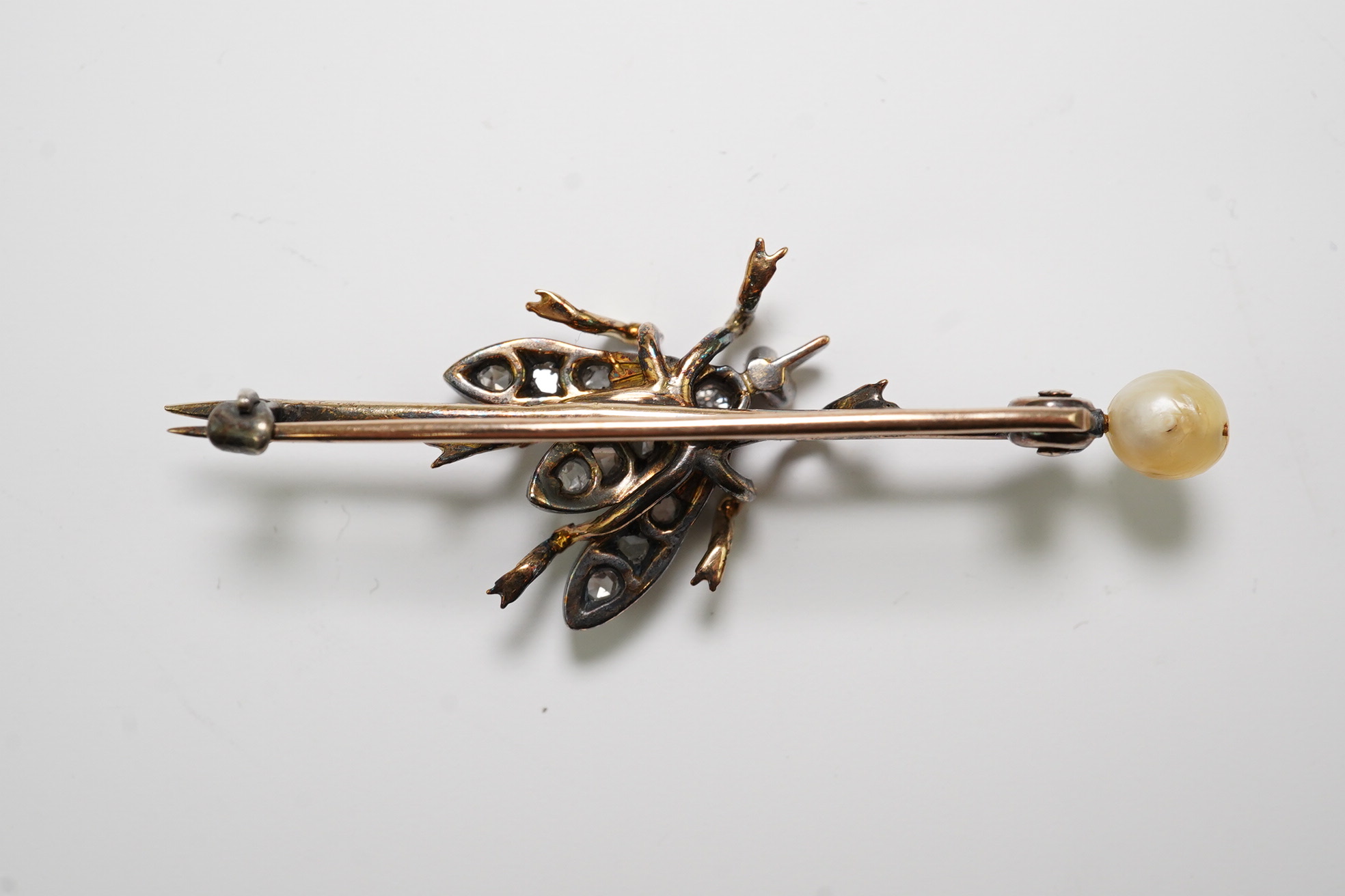 A Victorian gold and silver, pearl, rose and old cut diamond set 'bug' bar brooch